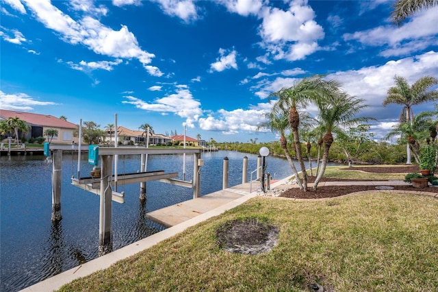 dock area with a water view and a yard