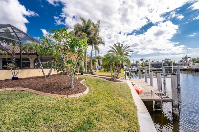 view of dock featuring a water view, a lanai, and a lawn