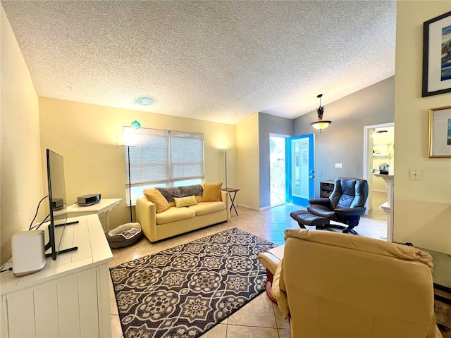 living room featuring vaulted ceiling, plenty of natural light, light tile patterned flooring, and a textured ceiling