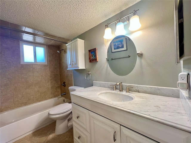 full bathroom featuring tile patterned flooring, tiled shower / bath combo, vanity, a textured ceiling, and toilet