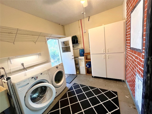 laundry room featuring separate washer and dryer and a textured ceiling