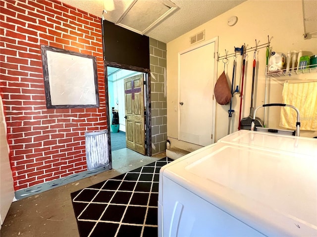 clothes washing area featuring washer / dryer and a textured ceiling