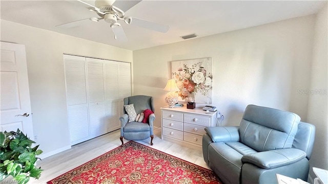 sitting room featuring ceiling fan and light wood-type flooring