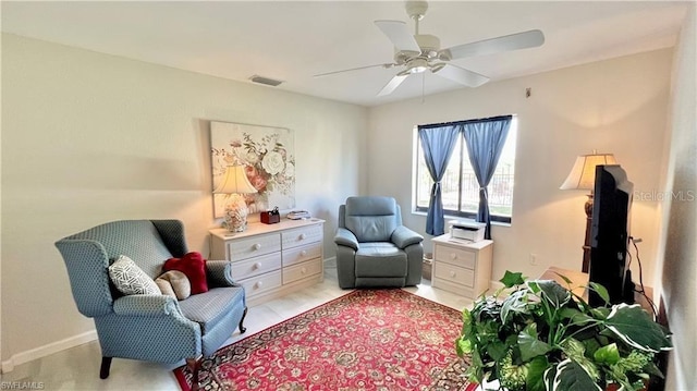 living area featuring ceiling fan