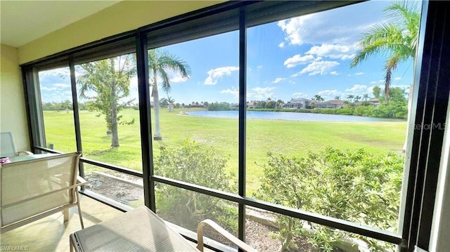 sunroom / solarium with a water view