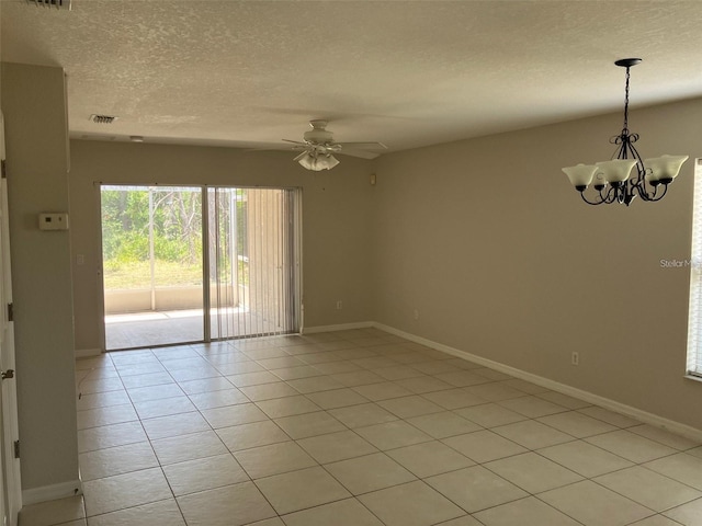 tiled empty room with ceiling fan with notable chandelier and a textured ceiling