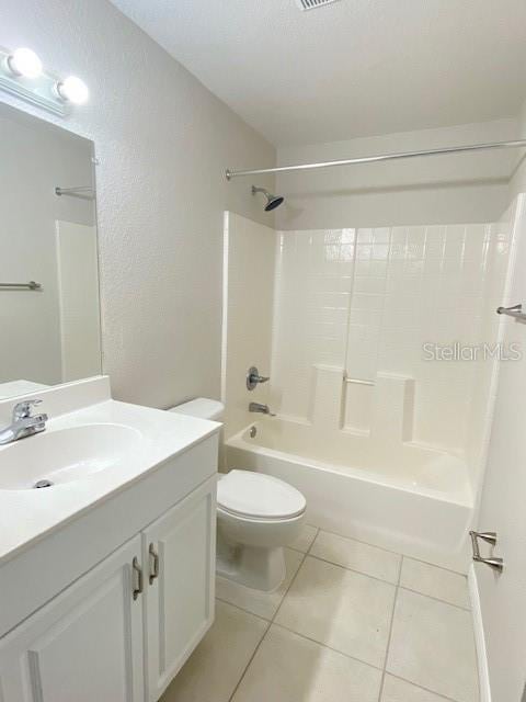 full bathroom featuring tile patterned floors, toilet, shower / washtub combination, and vanity