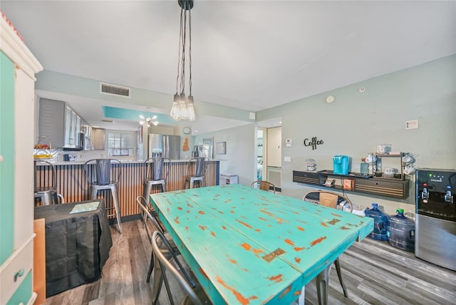 recreation room featuring hardwood / wood-style floors and a chandelier