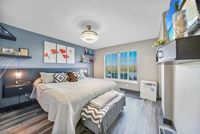 bedroom with dark hardwood / wood-style flooring