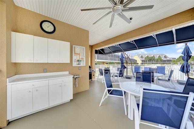 sunroom / solarium with ceiling fan and a healthy amount of sunlight