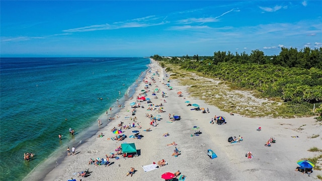 birds eye view of property featuring a water view and a view of the beach