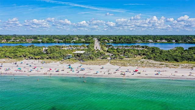 drone / aerial view with a water view and a view of the beach