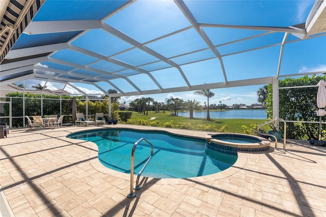 view of pool with an in ground hot tub, a patio, glass enclosure, and a water view