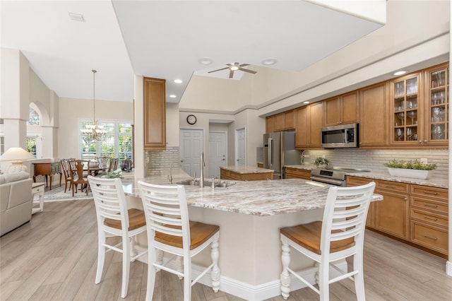 kitchen featuring pendant lighting, sink, a breakfast bar, stainless steel appliances, and kitchen peninsula