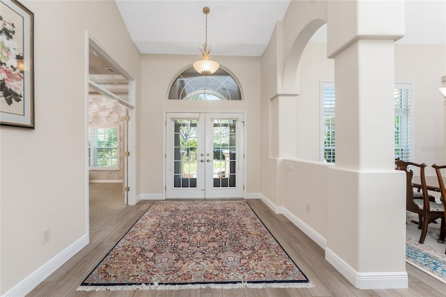 entrance foyer with light hardwood / wood-style floors and french doors