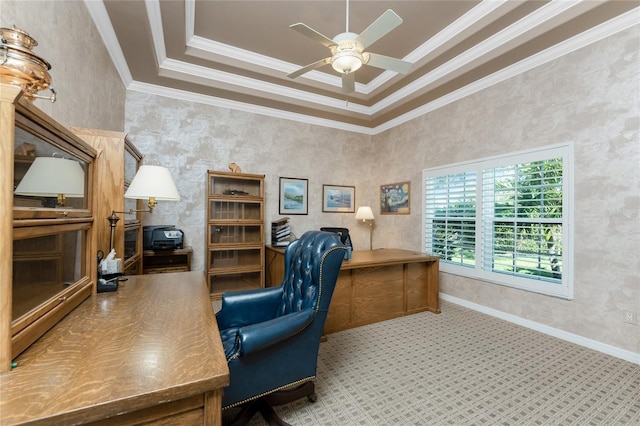 carpeted home office featuring crown molding, a tray ceiling, and ceiling fan