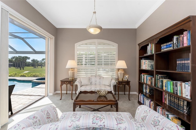 sitting room featuring ornamental molding and light carpet