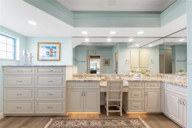 bathroom with crown molding, vanity, and hardwood / wood-style floors