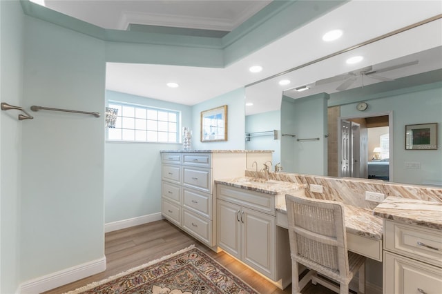 bathroom featuring vanity, hardwood / wood-style floors, and ornamental molding