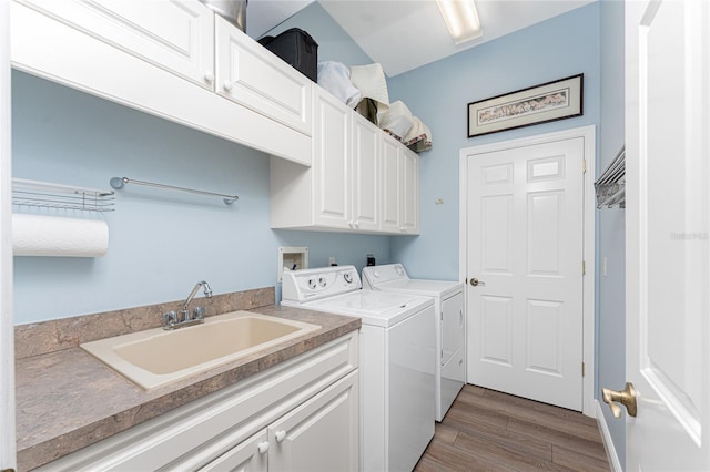 laundry room featuring cabinets, sink, dark wood-type flooring, and independent washer and dryer