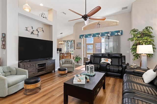 living room featuring ceiling fan, wood-type flooring, and high vaulted ceiling