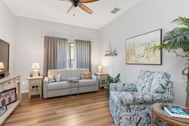 living room with ceiling fan and light hardwood / wood-style floors