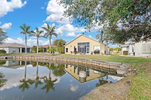 dock area with a yard and a water view