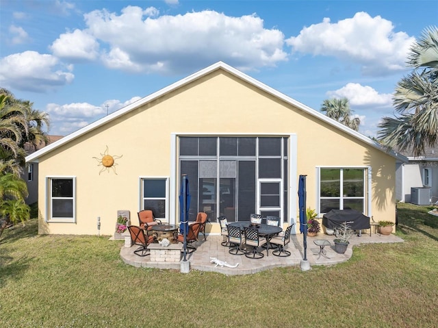 rear view of property featuring an outdoor fire pit, a yard, a patio, and central air condition unit