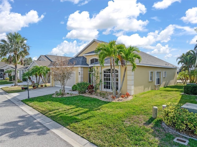 ranch-style home featuring a garage and a front yard