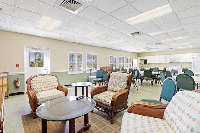 interior space with ceiling fan and a paneled ceiling