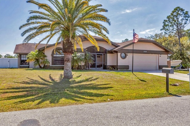 23239 Stelling Ave, Punta Gorda, FL 33980 - view of front of property with a front lawn, driveway, stucco siding, and a garage