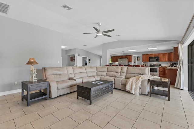 living area featuring light tile patterned floors, visible vents, a ceiling fan, and vaulted ceiling