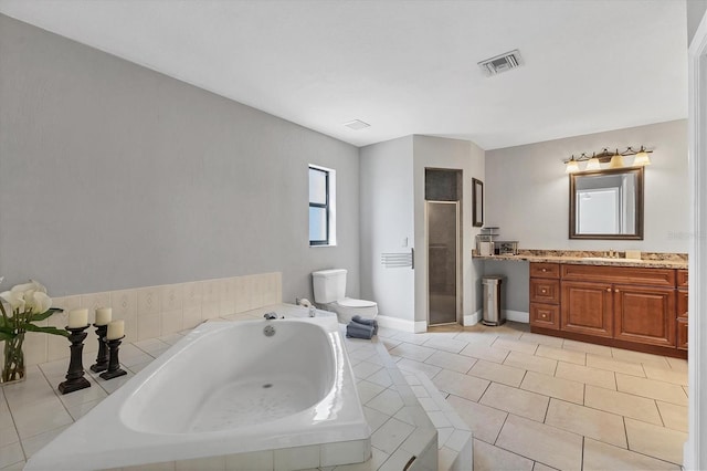 bathroom featuring vanity, a bath, a stall shower, tile patterned flooring, and toilet