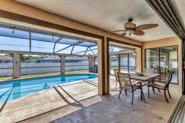 view of pool with a storage shed, a patio area, fence, and a lanai