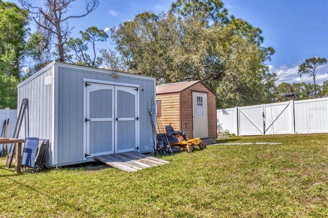 view of shed with fence private yard and a gate