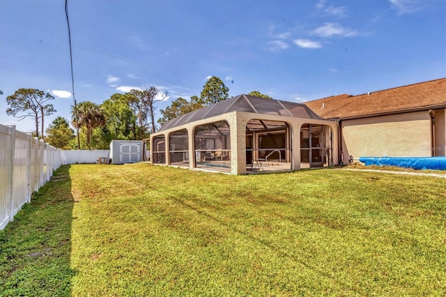 back of property featuring a fenced backyard, glass enclosure, a yard, a storage shed, and an outdoor structure