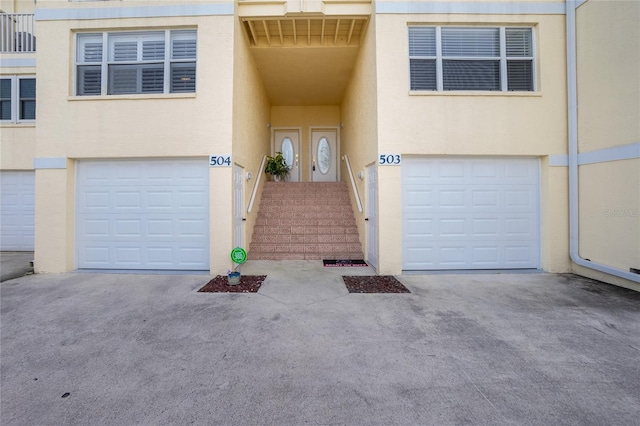 doorway to property with a garage