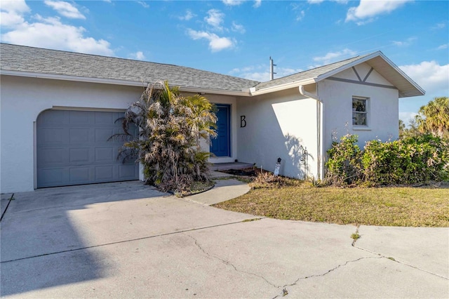 single story home with a garage and a front lawn