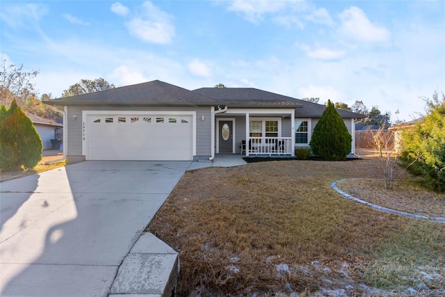 single story home with a garage, covered porch, and a front lawn