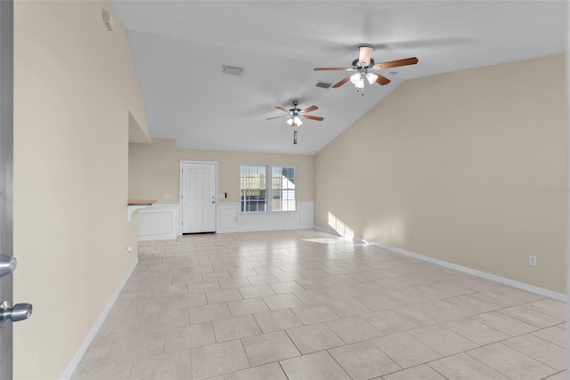 tiled spare room with vaulted ceiling and ceiling fan