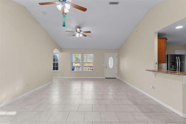 unfurnished living room with light tile patterned flooring, ceiling fan, and lofted ceiling