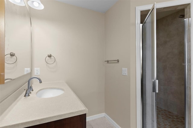 bathroom with tile patterned floors, a shower with shower door, and vanity