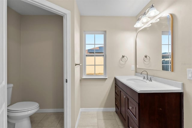 bathroom with tile patterned flooring, vanity, and toilet