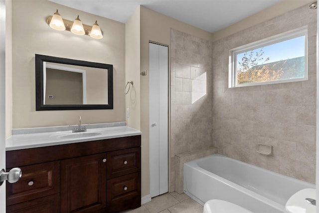 full bathroom featuring vanity, tiled shower / bath, tile patterned floors, and toilet