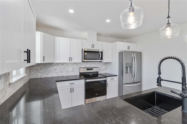 kitchen featuring pendant lighting, sink, white cabinets, and appliances with stainless steel finishes