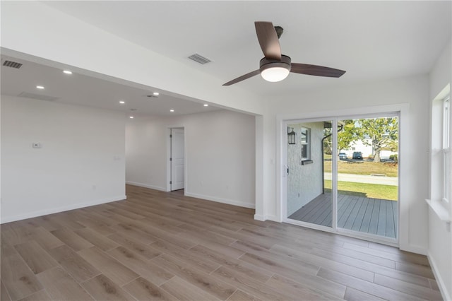 empty room with light hardwood / wood-style floors and ceiling fan