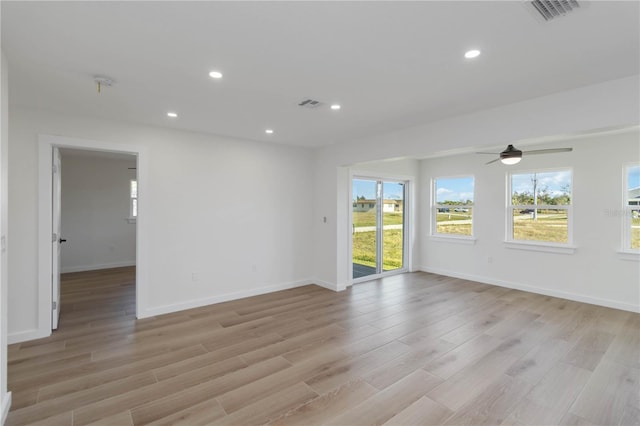 empty room with light wood-type flooring and a wealth of natural light