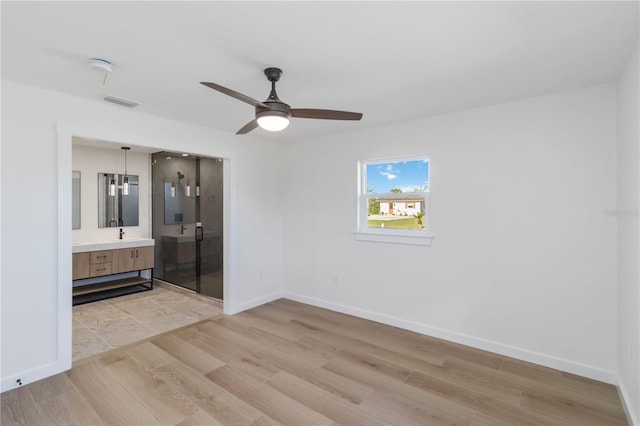 empty room featuring light hardwood / wood-style flooring and ceiling fan