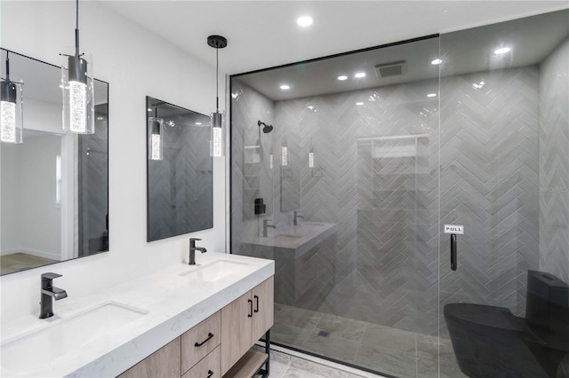 bathroom featuring vanity and a shower with door