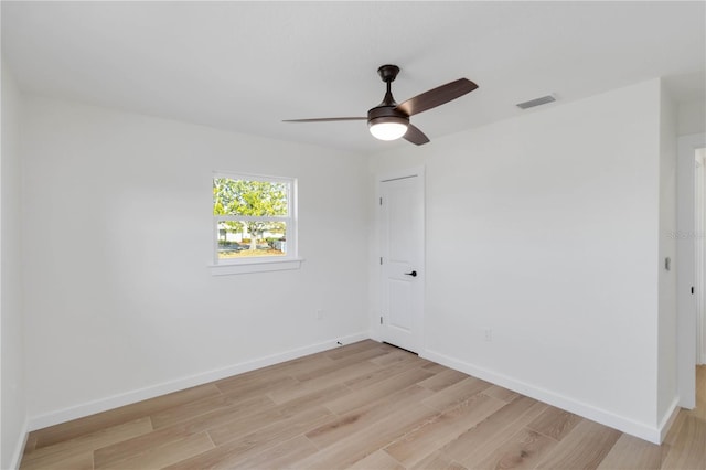 empty room with ceiling fan and light wood-type flooring